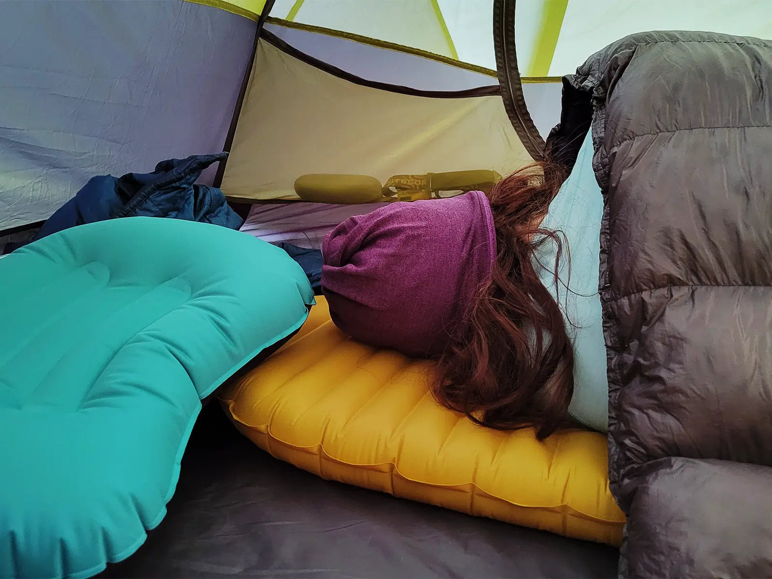 Camp pillow slid out from under head while camping on a sleeping pad in a tent