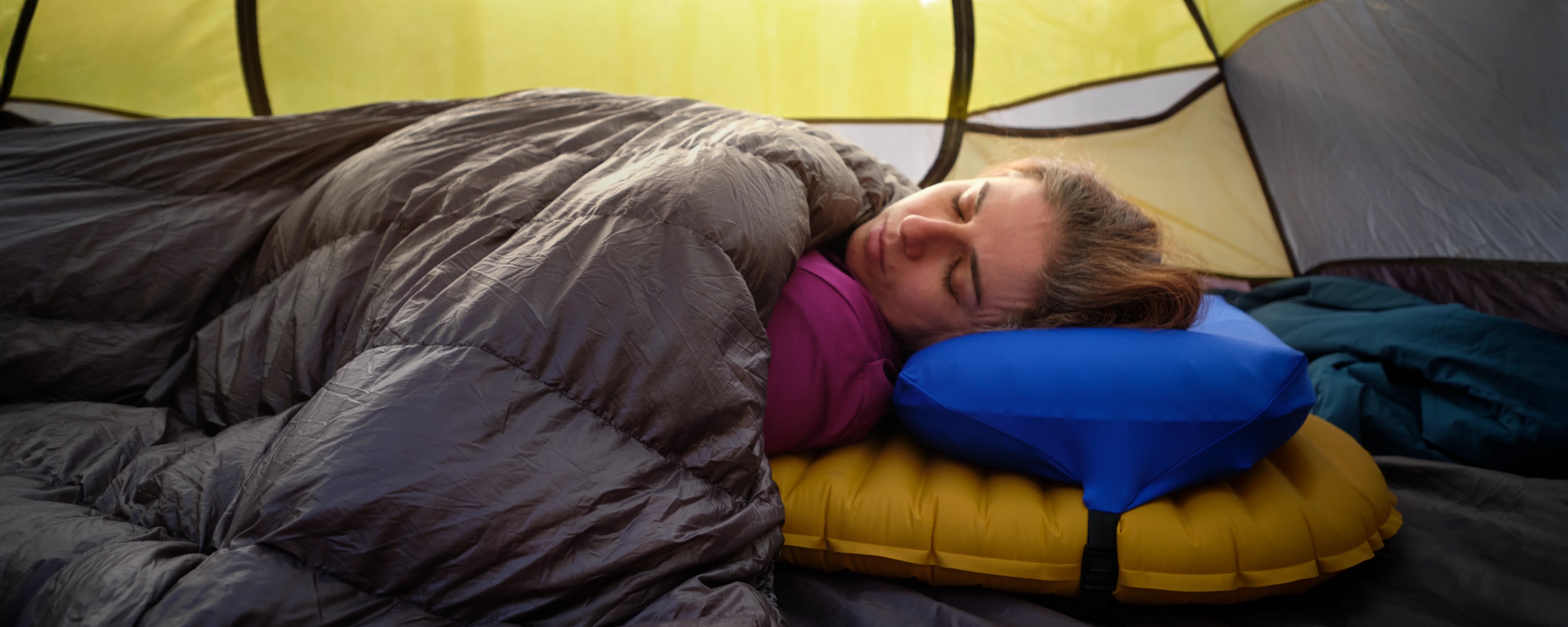 Blue Pillow Strap camping pillowcase used with a quilt on a Thermarest 20 inch wide sleeping pads in a tent 
