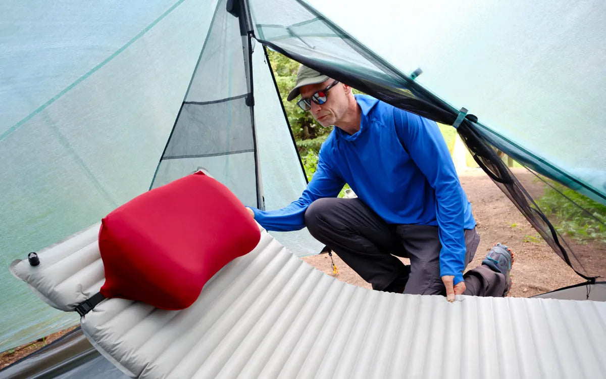 Pillow Strap securing a camping pillow to a sleeping pad inside a tent