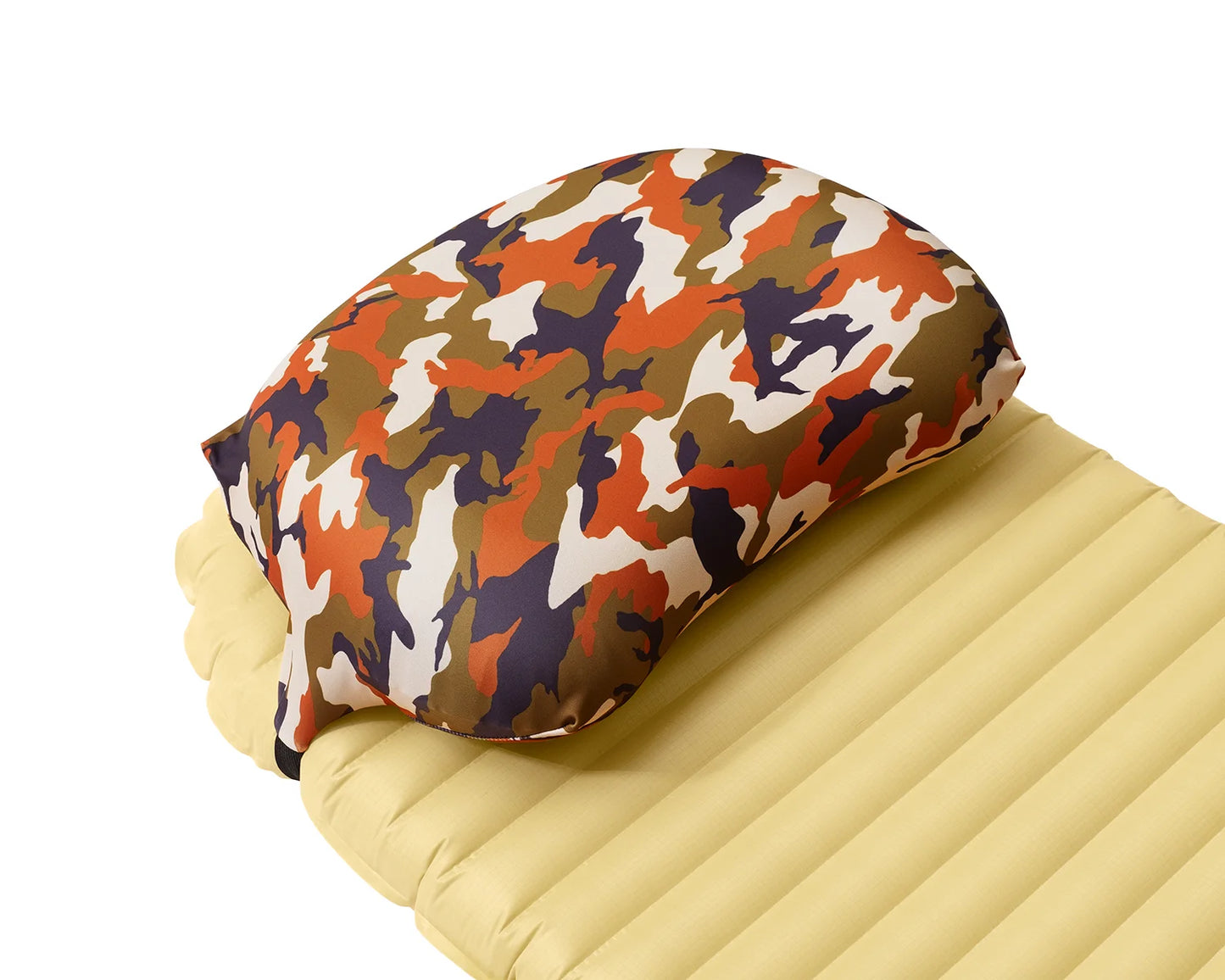 Pillow Strap medium size camping pillow case in forest camo on a sleeping pad. Three quarter view.