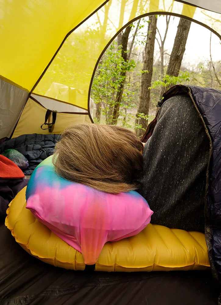 Woman sleeping with head on a Pillow Strap in tent camping